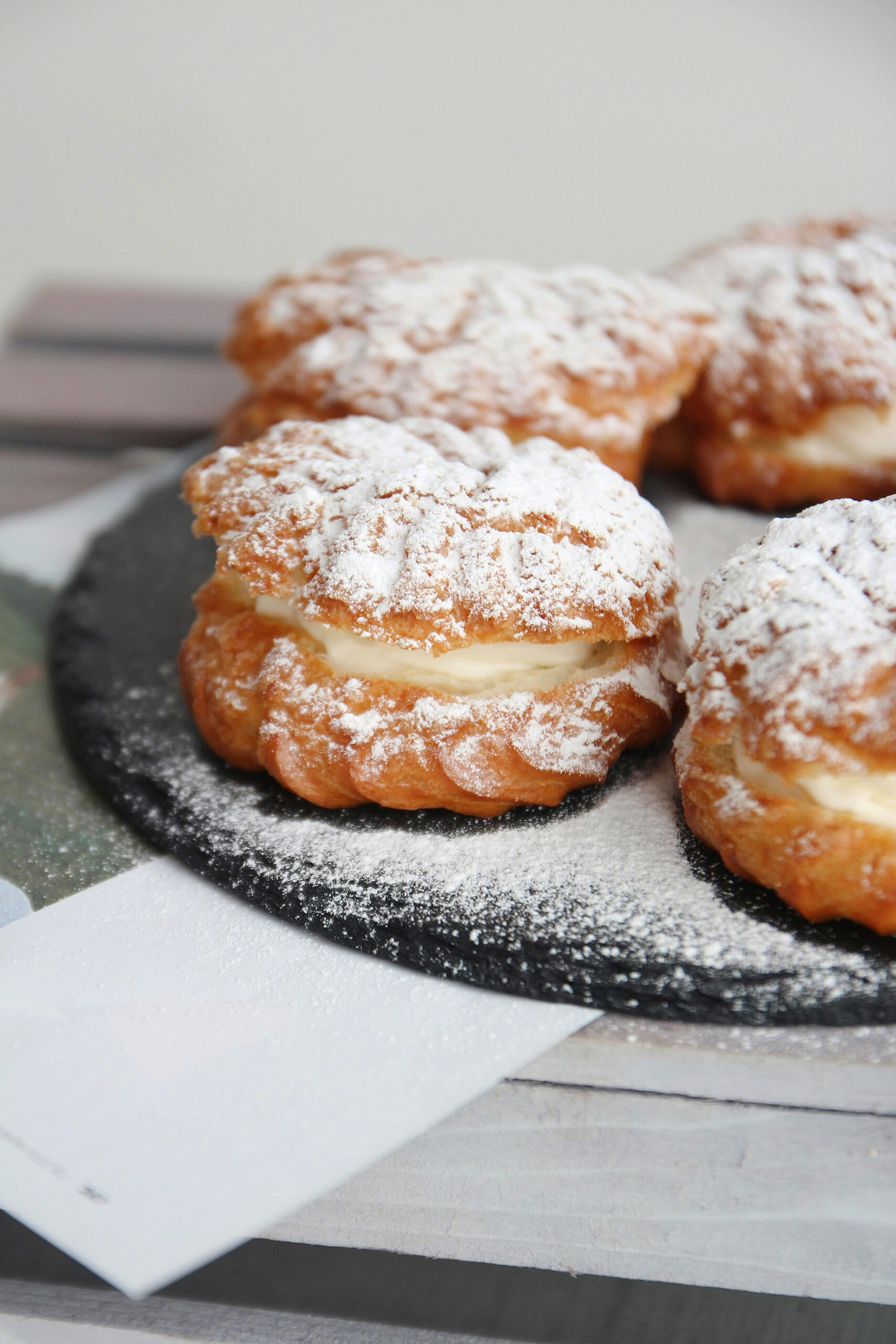 Soft Cream-Filled Pastries Dusted with Powdered Sugar